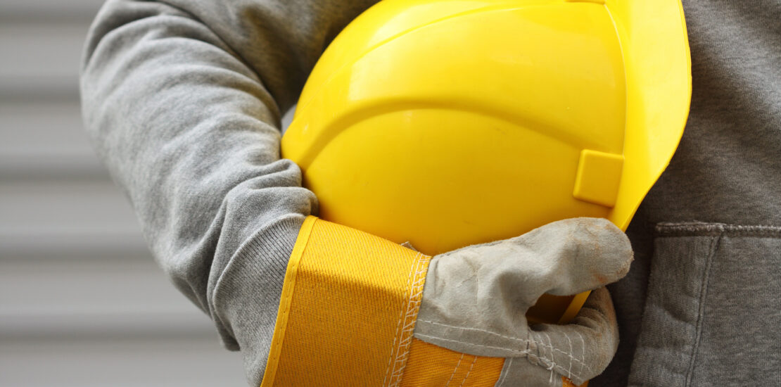 When Construction Workers Get Hurt At Work - Man holding yellow helmet close up