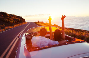 A Beginner's Guide To Road Trips - Romantic Couple Driving on Beautiful Road at Sunset