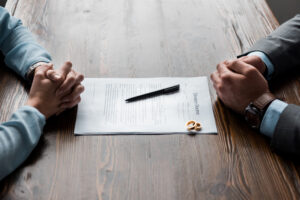 How A Divorce Lawyer Can Help You - divorce papers at table prepared to sign